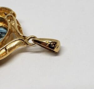 Gold pendant with "750" engraved on bail.