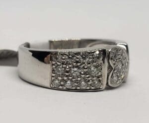 Silver ring with diamond accents on band.