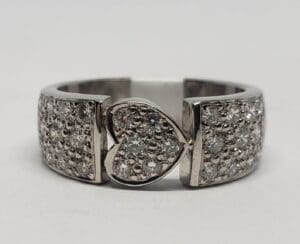 Silver ring with heart-shaped diamond design.