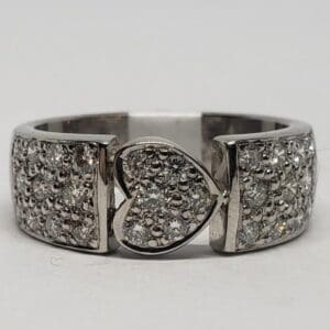 Silver ring with heart-shaped diamond centerpiece.