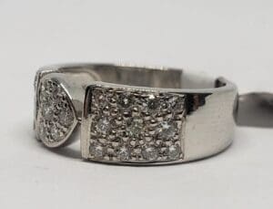 Silver ring with square diamond accents.