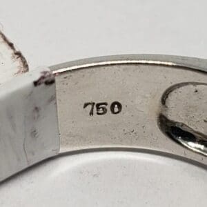 Ring with "750" hallmark engraved inside.