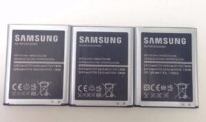 Three Samsung smartphone batteries on white background.