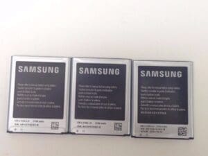 Three Samsung smartphone batteries on display.