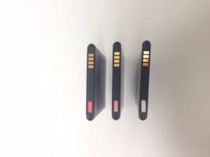 Three lithium-ion batteries with colored labels.