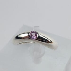 Silver ring with a purple gemstone.
