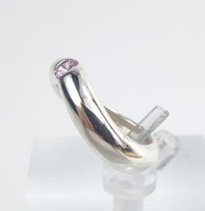 Silver ring with a pink gemstone.