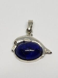 Silver bird-shaped pendant with blue stone.