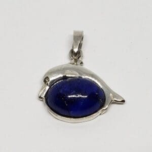 Silver dolphin pendant with blue stone.