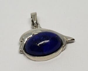 Silver pendant with blue gemstone accent.