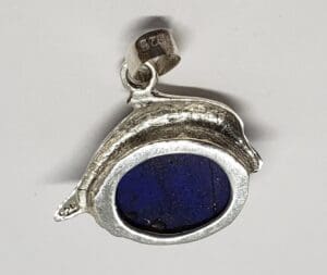 Silver pendant with dark blue stone.