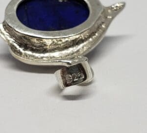 Silver jewelry with blue stone, marked 925.