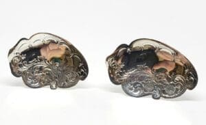 Ornate silver belt buckles with floral design.