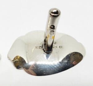 Silver object with vertical cylindrical rod.