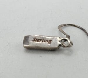 Sterling silver earring with hook attachment.