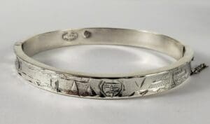 Silver bangle with engraved geometric patterns.