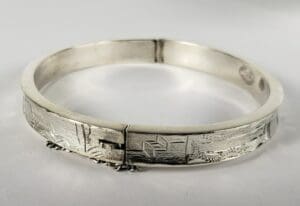 Silver engraved bracelet with latch clasp.