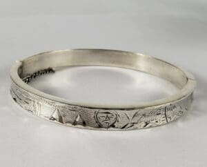 Silver engraved bracelet with geometric patterns.