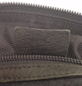 Black zipper with leather tag and numbers.