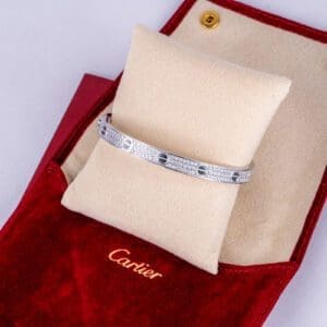 Silver bracelet in red Cartier jewelry box.