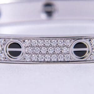 Silver bracelet with diamond and black accents.