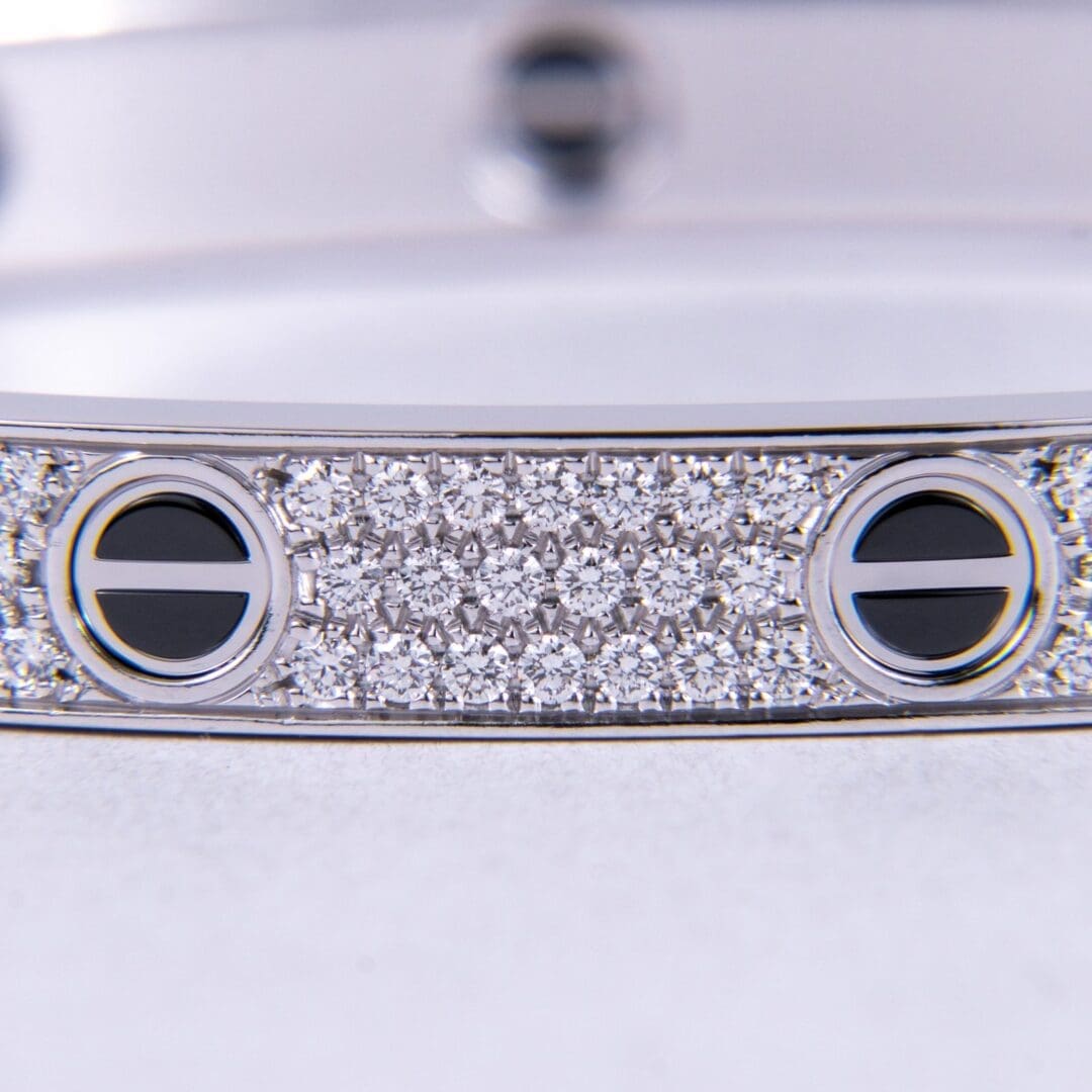 Silver bracelet with diamond and black accents.