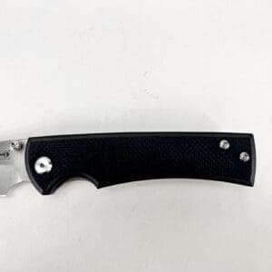 Black-handled folding knife on white background.