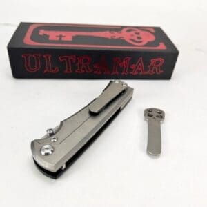 Folding knife with box and key-shaped tool.
