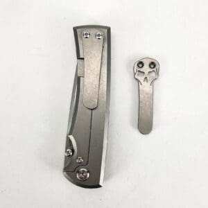 Knife clip and skull-shaped accessory.