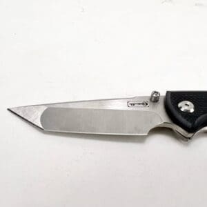 Sharp folding knife on white background.