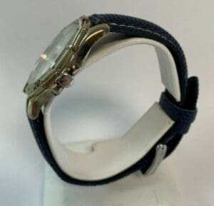 Silver watch with blue fabric strap.