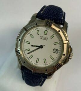 Silver Citizen watch with blue fabric strap.