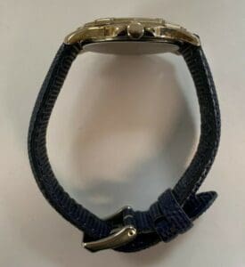 Silver watch with a blue fabric strap.