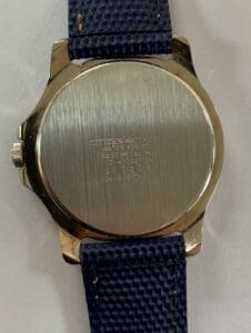 Back of a Citizen watch with text.
