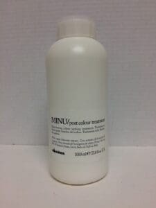 White bottle of MINU hair treatment product.