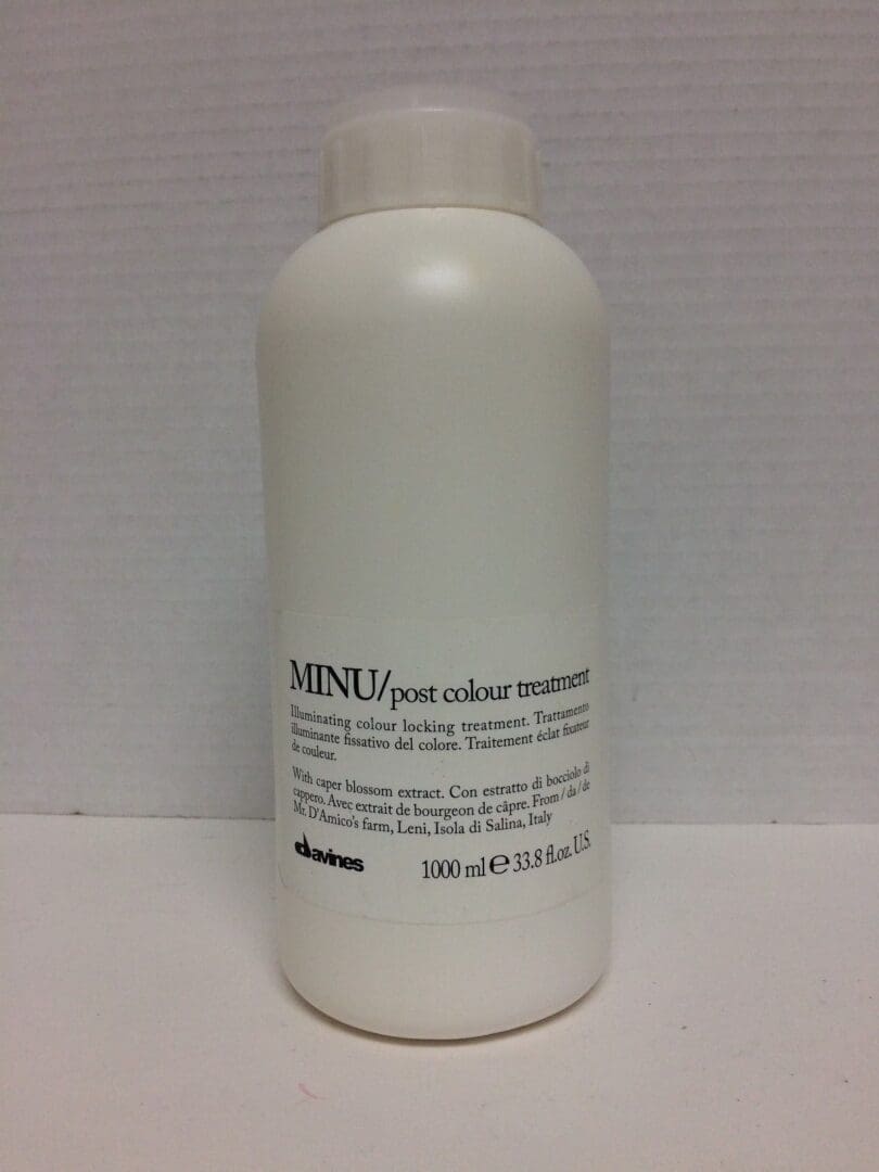 White bottle of MINU hair treatment product.