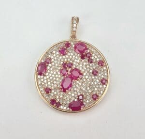 Gold pendant with diamonds and rubies.