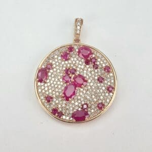 Gold pendant with diamonds and rubies.