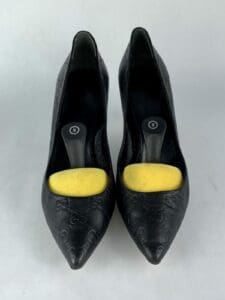 Black high heels with yellow inserts.