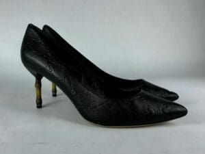 Black high heels with patterned texture.