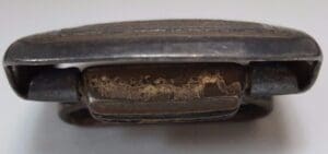 Close-up of a worn metallic buckle.
