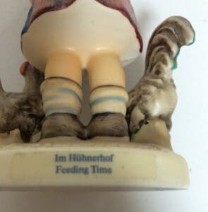Porcelain figurine of child with chickens.