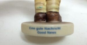 Figurine base with "Good News" text.