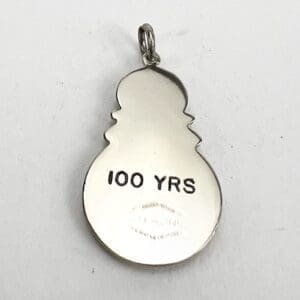 Snowman pendant with "100 YRS" inscription.
