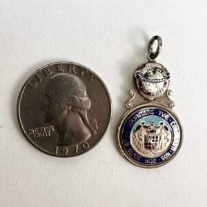Coin and a blue enamel medallion.