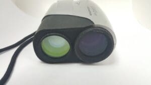 Rangefinder device with two lenses and strap.