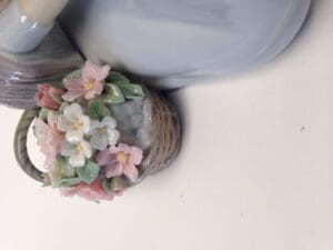 Porcelain teapot with floral basket decoration.