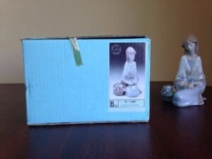 Box and figurine on a wooden table.