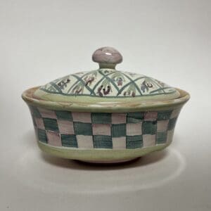 Decorative ceramic bowl with patterned lid.