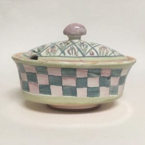 Decorative ceramic bowl with lid and patterns.